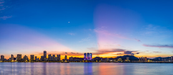 Fototapeta premium Beautiful coastline and modern building scenery at sunset by the sea, Zhuhai, Guangdong Province, China.