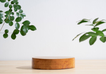 Wooden podium table top blurred green leaf plant on white empty space nature background.Beauty cosmetic natural product modern stage display.