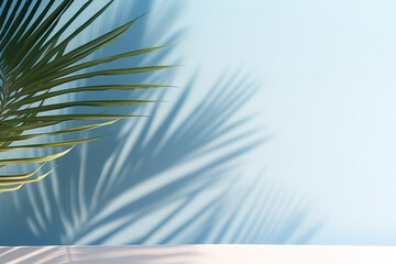 Blurred shadow from palm leaves on the light blue wall. Minimal abstract background for product presentation. Spring and summer.