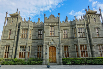 Fototapeta premium Vorontsov Palace in Crimea in summer. Ancient walls with many columns, turrets and domes. An architectural masterpiece, the legacy of the ancestors. Green trimmed bushes
