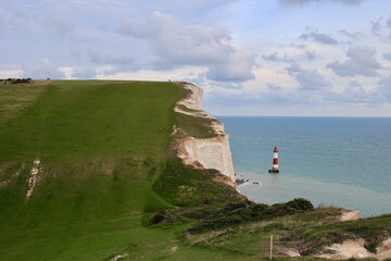 Fototapeta na wymiar Seven Sisters. The South Downs National Park. White chalk cliffs, view of the Beachy Head Lighthouse, Eastbourne, East Sussex, England.