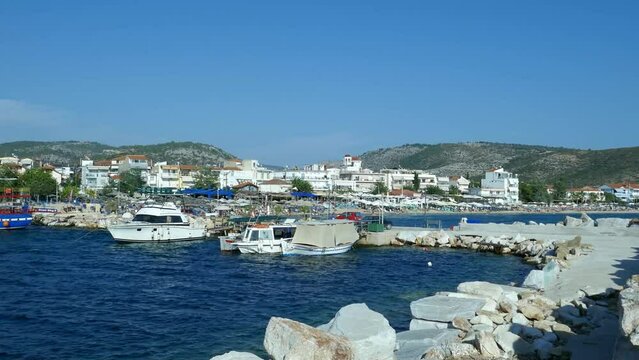 Potos is a tourist attraction in southern part of the Thassos Island , Greece , seen here from the pier , the fisherman boats , specific architecture and the blue Aegean sea , sunny summer day.