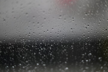 Water drops on fogged glass with a gray brightness gradient