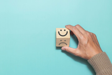 Hand flip wooden cube change smile face emoticon give a five star rating with rating feedback scale. Concept of service rating, satisfaction and feedback - obrazy, fototapety, plakaty