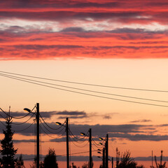 Electric line against colorful sky at sunset