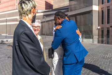 Fototapeta na wymiar Multi-ethnic group of business people embracing in an outdoor meeting