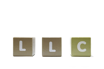 LLC Limited Liability Company text on wooden cubes isolated on a white background.