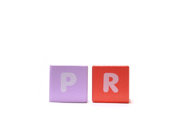 text PR Public Relations on colorful wooden isolated on a white background