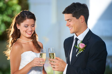Happy couple, wedding and champagne glasses in celebration for marriage, love or commitment at outdoor ceremony. Married man and woman smile with alcohol for toast, date or cheers on honeymoon