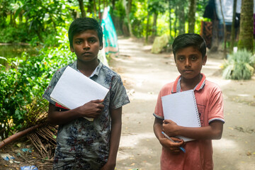 Portrait of Bangladeshi rural students with books and notebooks in their hands 