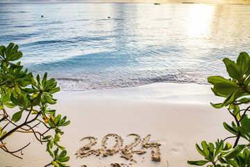 2024 written in sand on a tropical island