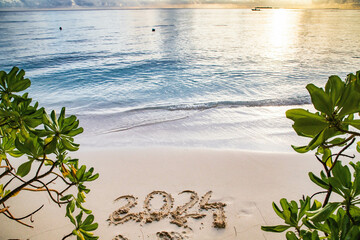 2024 written in sand on a tropical island