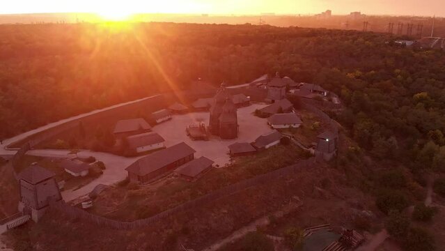 Zaporozka Sich fortress as captured from drone during a sunset. This aerial footage bathes the historic site in the golden glow of dusk.