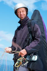 Paragliding, parachute and man with portrait in nature in preparation, exercise or health support....