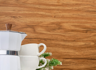 Coffee break in office. Metallic coffee maker and white ceramic cups. Copy space for text.