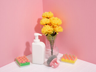Healthcare and sanitation at home concept. Beautiful yellow flowers in a vase. Cleaning dishes.