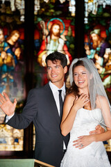 Couple, face and happy in church for wedding, ceremony or event with commitment, wave and union. Marriage, man and woman with smile, joy and love for celebration, loyalty and trust with suit or dress