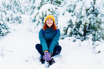 Young smiling woman enjoys snowy winter day. High quality photo