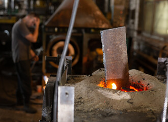 Ferrous metal billet is melted in an induction furnace closeup