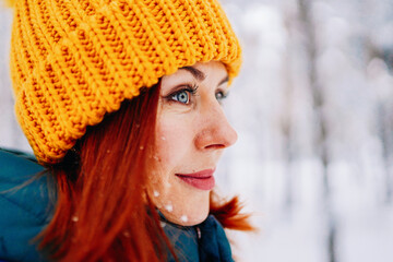 Young smiling woman enjoys snowy winter day. High quality photo