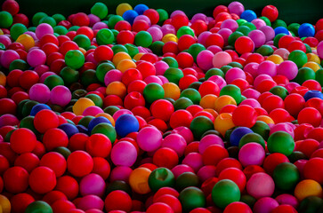 Colored plastic balls in pool of game room.