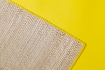 Mat detail on yellow background. Treadmill concept. Summer concept. Copy space.