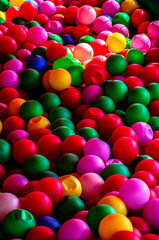 Colored plastic balls in pool of game room.