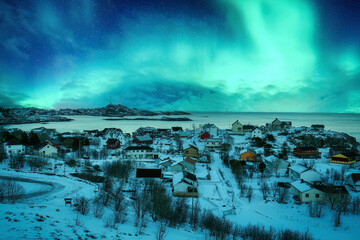 Aurora borealis over snowy A nordland village of Moskenes at Lofoten Islands, Norway