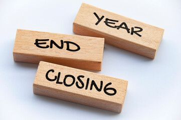 Top view of Year End Closing text on wooden blocks.