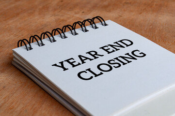 Year end closing text on white notepad. Year end closing concept