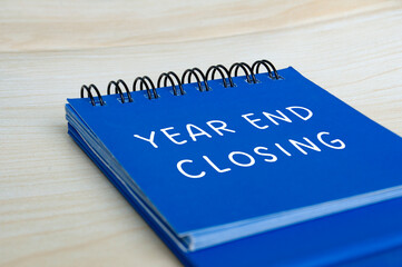 Year end closing text on blue notepad. Year end closing concept