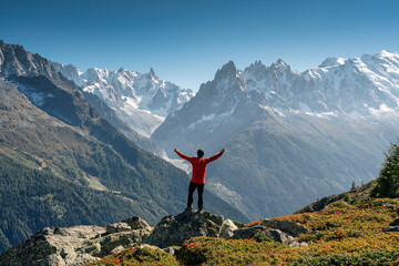 A male hiker standing with enjoying the Mont Blanc mountain range view during trail in Lac Blanc at France