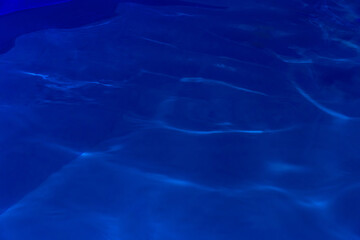 Blue dark clear pool water abstract nature pattern reflection wave surface transparent underwater deep background