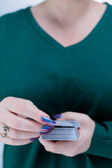 Female hands holding tarot cards for fortune telling and tricks