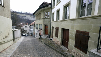 Empty traditional European street with nobody. Cobblestone sidewalk with ancient buildings