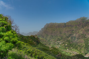 Obraz premium Grand valley view with volcanic mountains surrounding with green grass on Santo Antao Island, Cape Verde