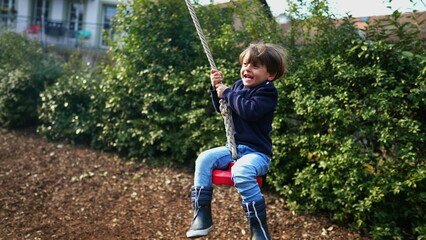 Excited Child in Close-Up, Gripping and Sliding on Wire Rope Between Trees
