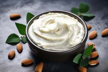 Wandaufkleber DIY Almond Cocoa Body Butter for Beauty and Care. Aromatherapy Cleanse in Bowl on Concrete Background © AIGen