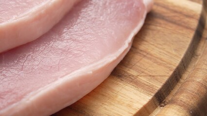 Dolly shot of Sliced Pork Loin on Wooden Board.