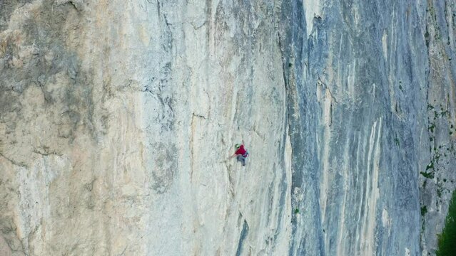 The Adventurous Ascent: A Fearless Man Scaling the Majestic Cliffside