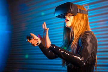 Blonde woman immersed in a vitual experience using VR goggles
