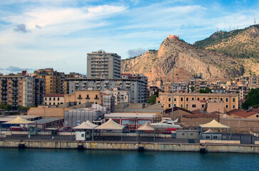 Panoramic view of the docks in the port of Palermo. Cityscape and mountain range on horizon. Travel and tourism concept
