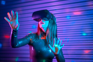 Female gamer wearing augmented reality goggles in a futuristic space