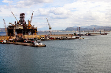 Panoramic landscape view of semi-submersible drilling vessel in dock of Palermo port. Vessel under renovation