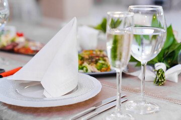 Serving the banquet table with cutlery and snacks. 