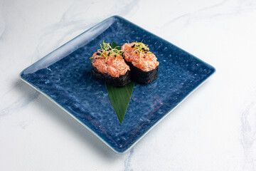 Japanese cuisine. Gunkan on blue plates
