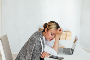 Business woman tired at work in office at computer