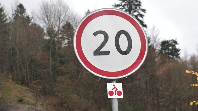 road sign speed limited to 20 in the rain close-up, speed limit sign 20 mph, speed limit sign