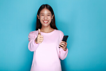 Portrait of cute elegant blackhead girl showing thumbs up, A pretty young girl giving thump sing in happiness as a sign of approval or yes isolated, Young happy woman holding thumbs up isolated.