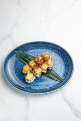 Japanese cuisine. Delicious Rolls with salmon and cheese fries
